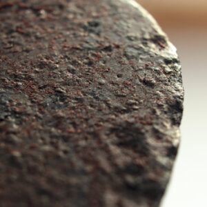close up of blackened spade head where rust converter has chemically changed iron oxide into iron tannate