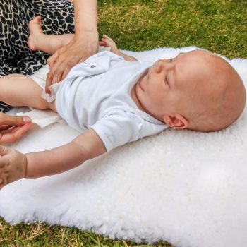 sheepskin being used as a changing mat in the park